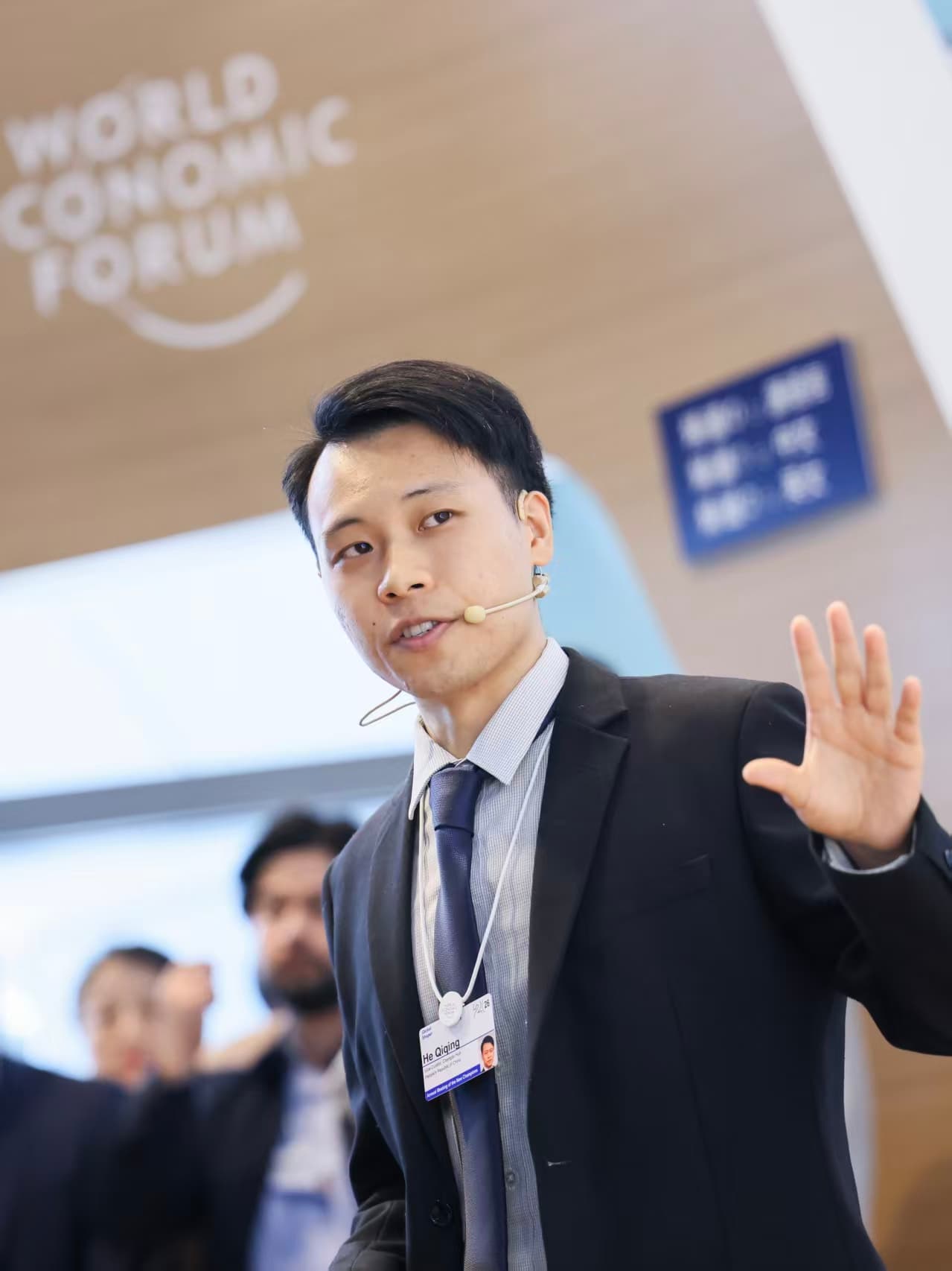 Qiqing He speaking with a headset microphone at a World Economic Forum Summer Davos Hub Session
